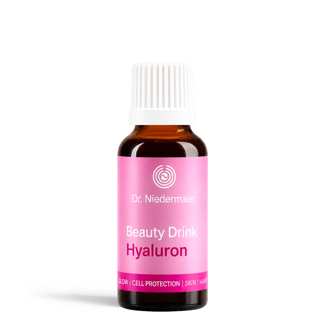 Brown glass bottle with white cap and pink label reading Dr Niedermayer Beauty Drink Hyaluron on a white background